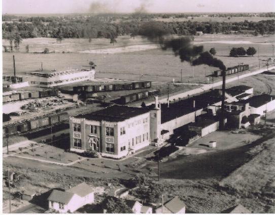 Built in 1911 along South Evans Street, Uncle Sam's Macaroni Company went under due to the expenditures and the plant was sold to Quaker Oaks.  Later this plant was retrofitted to manufacture cardboard boxes for the Tecumseh Corrugated Box Company. Across South Evans lies the railroad yard operated at the time of this picture (ca. 1917) by the New York Central Railroad Company.  NYC had rail spurs leading into Quaker Oats as well as the Anthony Fence Company factory, which later was owned by Tecumseh Products, lying east of the rail yard.